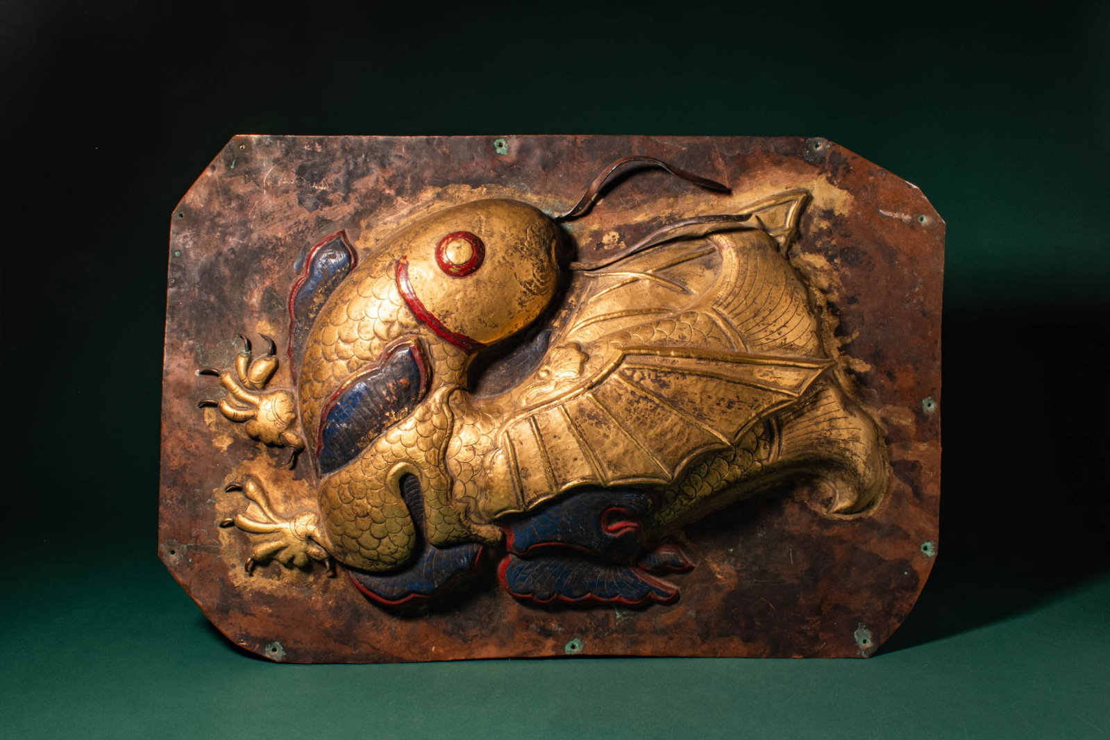 LARGE TIBETAN GILDED AND PAINTED REPOUSSE PANEL DEPICTING A DRAGON FISH (1 of 6)