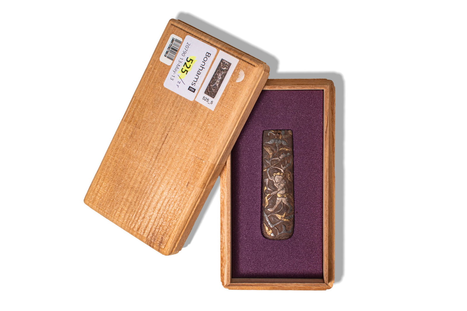 JAPANESE KOZUKA WITH NANBAN DESIGNS: Ca. AD 1700 - 1900. A kozuka made of shakud_ (a darkened copper-gold alloy), and it is decorated in iroe takaz_gan (multi-metal inlay in high relief), featuring a botanical scene and Nanban designs. S