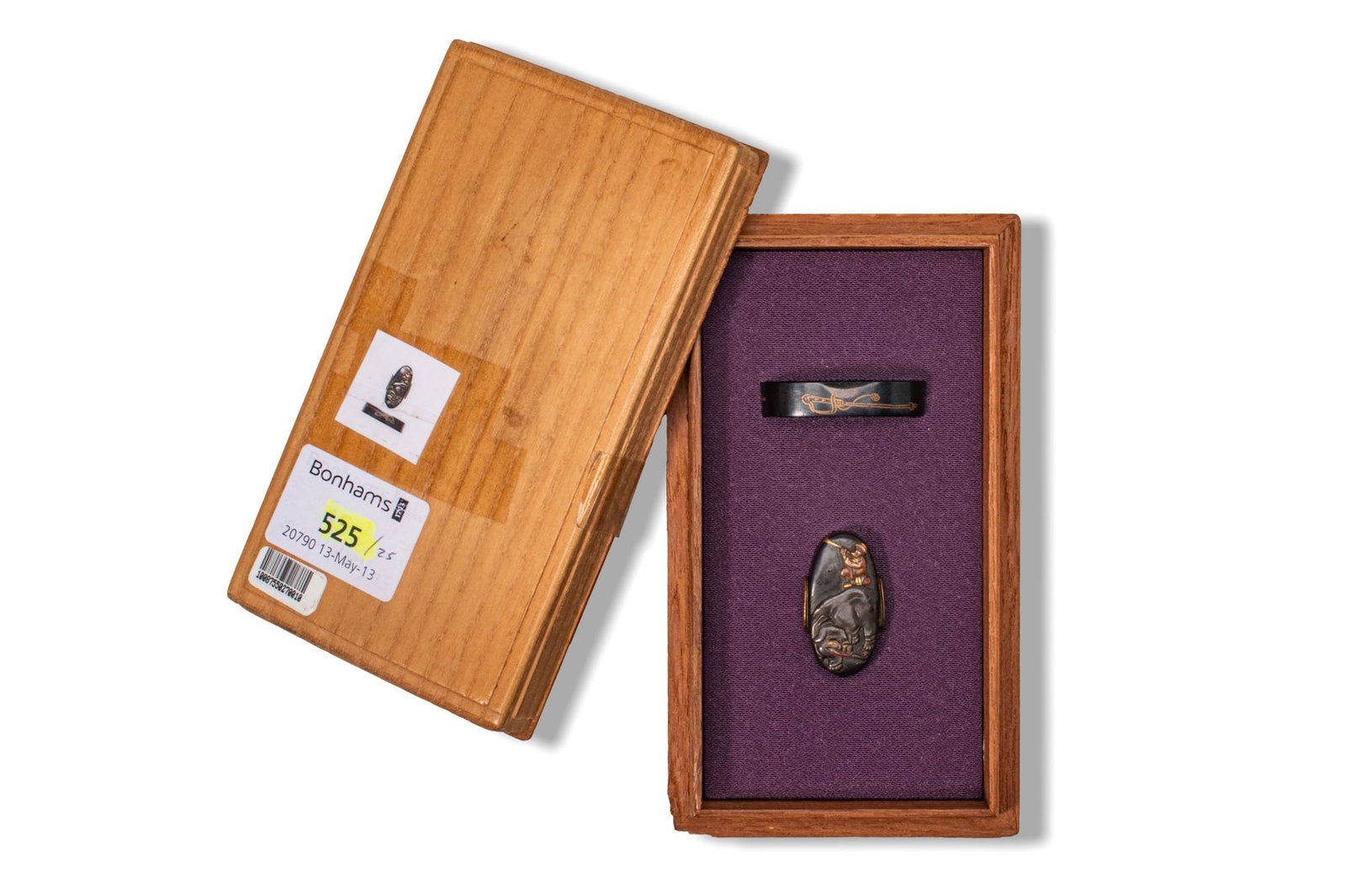 SET OF JAPANESE FUCHI-GASHIRA: Ca. AD 1700 - 1900. A set of fuchi-gashira of shakudo cast and inlaid in iroe takazogan (multicolored high-relief inlay) with a richly adorned mahout riding an elephant. Size: 33-35mm x 16-20mm; Weigh