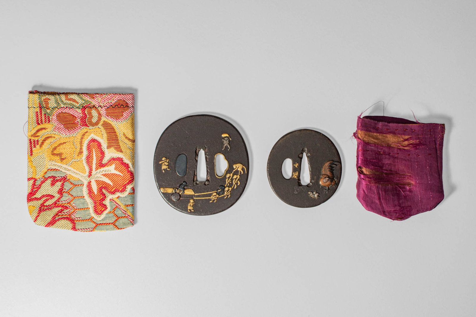 JAPANESE TSUBA, ANONYMOUS AND SIGNED YASUCHIKA: Edo Period, Ca. 18th-19th century AD. A group of two finely crafted iron tsuba, one unsigned and the other signed by Yasuchika, a master of the Nara school. Both pieces display exquisite taka-z_gan (h