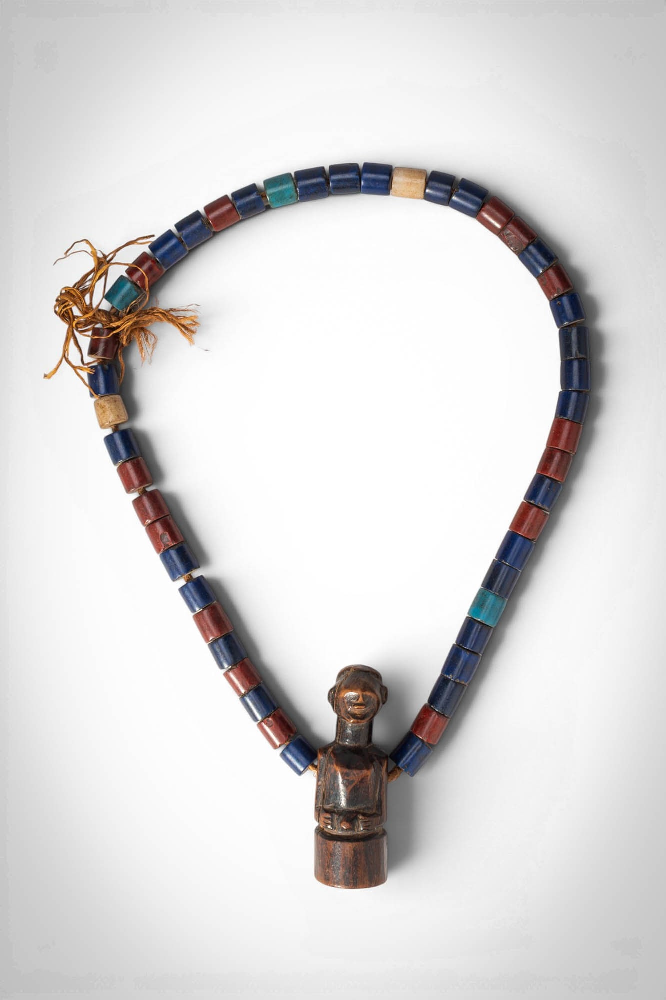 AFRICAN SONGYE NECKLACE: Democratic Republic of the Congo, Ca. 19th - 20th century AD. >A beautiful necklace composed of cylindrical glass trade beads in alternating blue, red, and occasional green and white tones, strung on 