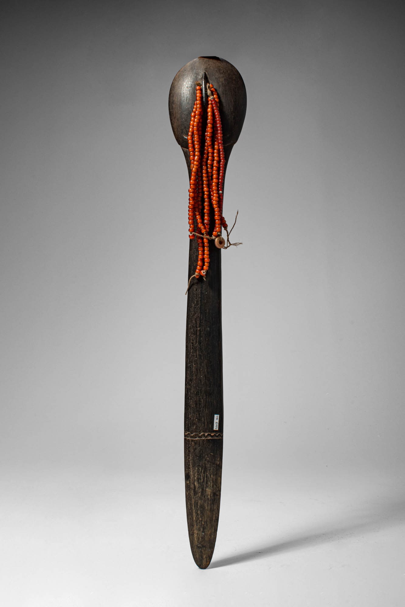 CENTRAL AFRICAN HAIRPIN: Ca. early 20th century AD. >A hairpin carved from a single piece of dark hardwood, of elongated tapering form, terminating in a rounded, bulbous finial. The shaft narrows to a pointed tip, designed fo