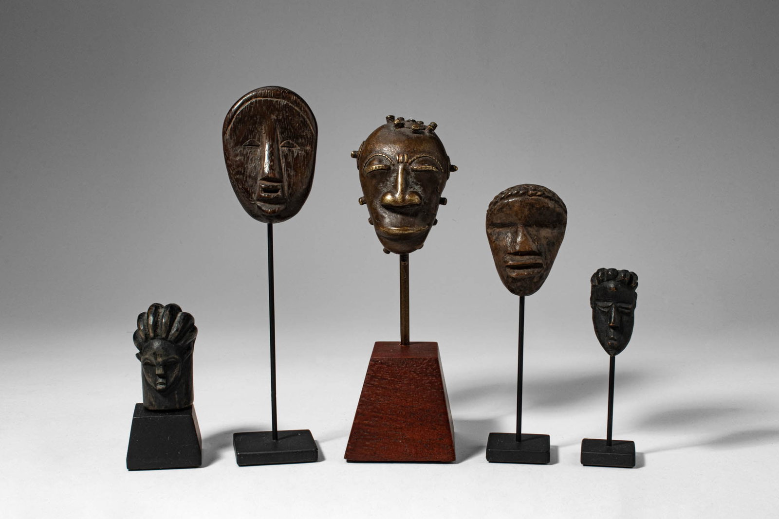 GROUP OF PASSPORT MASKS AND A BAULE MASKETTE (1 of 4)