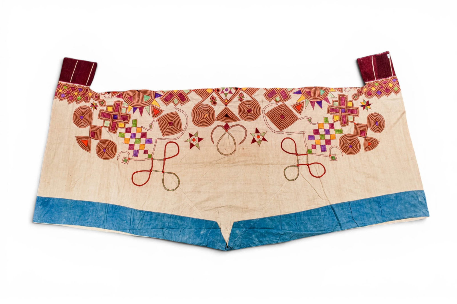 HAUSA MEN'S COSTUME IN WHITE COTTON: Ca. AD 1920 - 1930. >A large pair of embroidered trousers and a very large tunic, both executed in white cotton. The trousers are richly decorated with polychrome embroidery in coloured silks, featuri