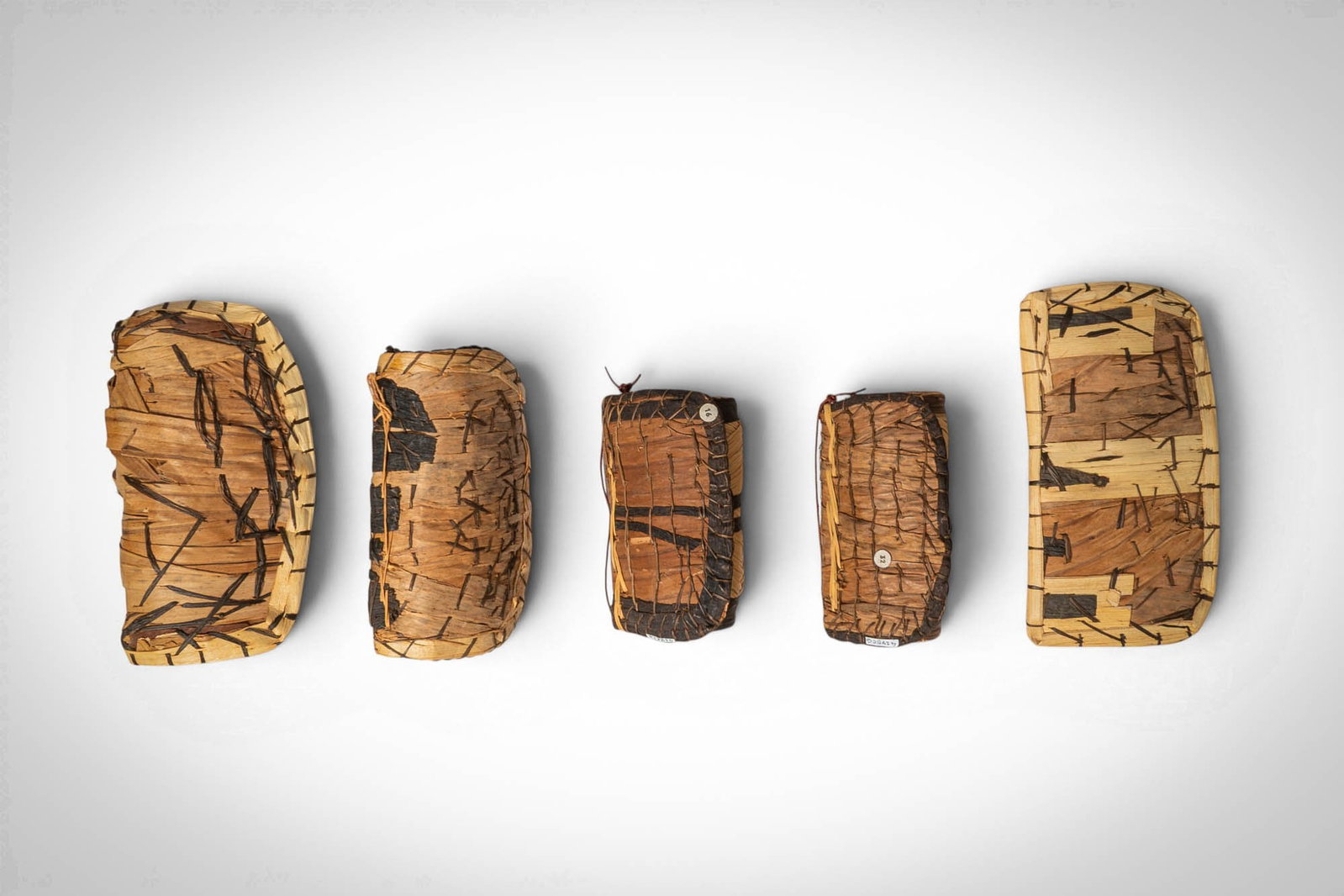 GROUP OF MANGBETU NEGBE: Ca. 20th century AD. >A group comprising five negbe, each incised with linear and abstract motifs and retaining traces of dark pigment within the carved lines. >Provenance: Prince collection, 1990s-20