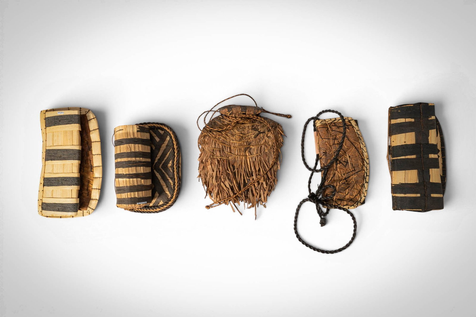 GROUP OF MANGBETU NEGBE: Ca. 20th century AD. >A group comprising five negbe, each incised with linear and abstract motifs and retaining traces of dark pigment within the carved lines. >Provenance: Prince collection, 1990s-20