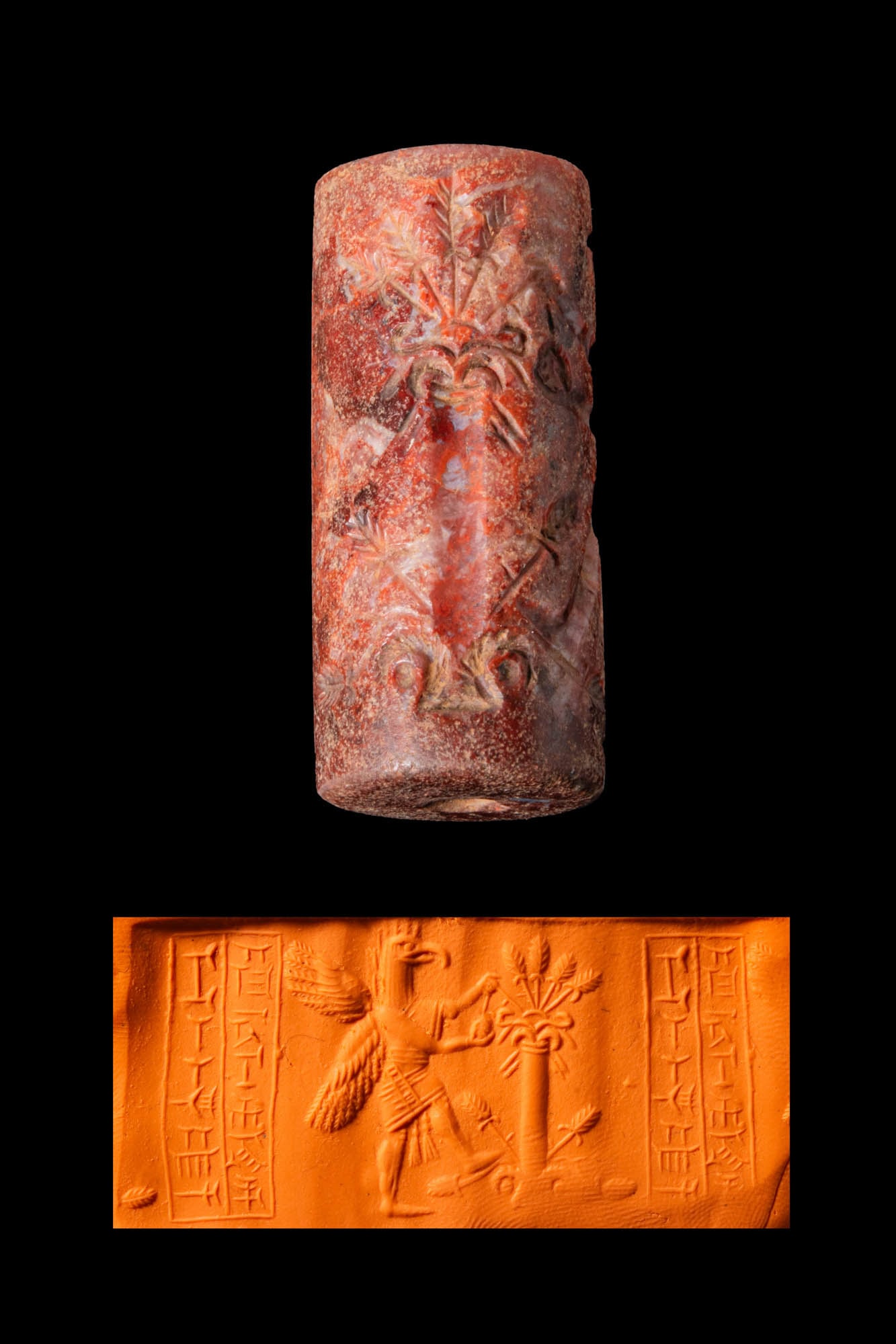 MIDDLE BABYLONIAN OR KASSITE REDDISH STONE CYLINDER SEAL WITH A BIRD-HEADED GENIUS, A TREE OF LIFE,: Ca. 1400 - 1200 BC. A reddish stone cylinder seal, drilled longitudinally and engraved with a two-winged bird-headed genius picking fruit from a tree of life. Two columns of cuneiform script are in th