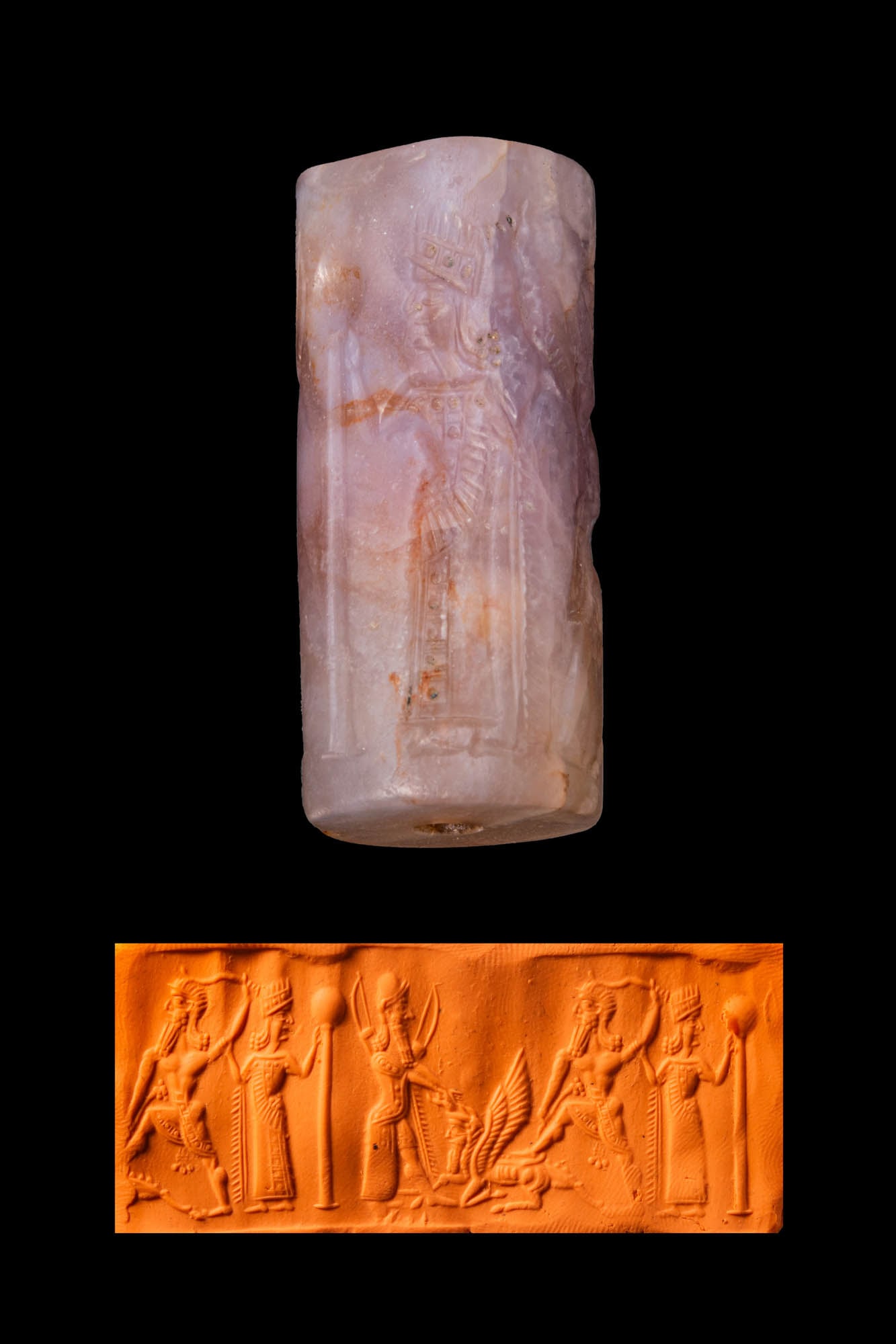 MESOPOTAMIAN AMETHYST CYLINDER SEAL WITH A SMITING HERO AND ATTENDANT FIGURES: Ca. 1000 - 700 BC. An amethyst cylinder seal, drilled longitudinally and engraved with a smiting hero fighting a mythical creature, accompanied by a warrior deity and a figure grasping the hero’s ar