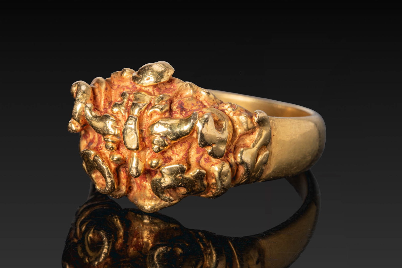 MEDIEVAL JAVANESE GOLD RING WITH ELEPHANTS: Ca. AD 700 - 1000. A gold ring with a tapering hoop and a broad, raised bezel decorated with four elephants in relief. Size: D:16.31mm / US: 5 3/4 / UK: L; Weight: 8.5g Provenance: From a private