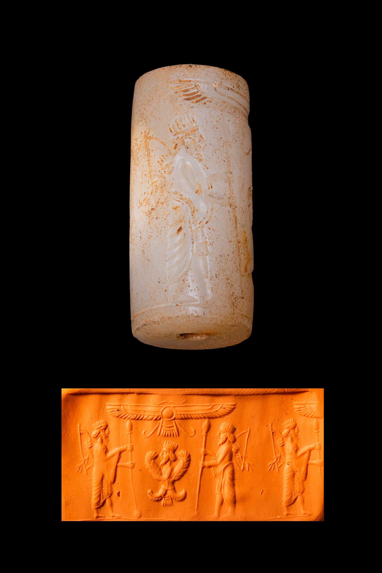 GREEK PERIOD WHITISH STONE CYLINDER SEAL WITH GUARDIAN FIGURES AND A WINGED BUST: Ca. 500 - 300 BC. A whitish stone cylinder seal, drilled longitudinally and engraved with two guardian figures flanking a four-winged royal bust, with a winged solar disk above. Size: 36mm x 16mm; Wei