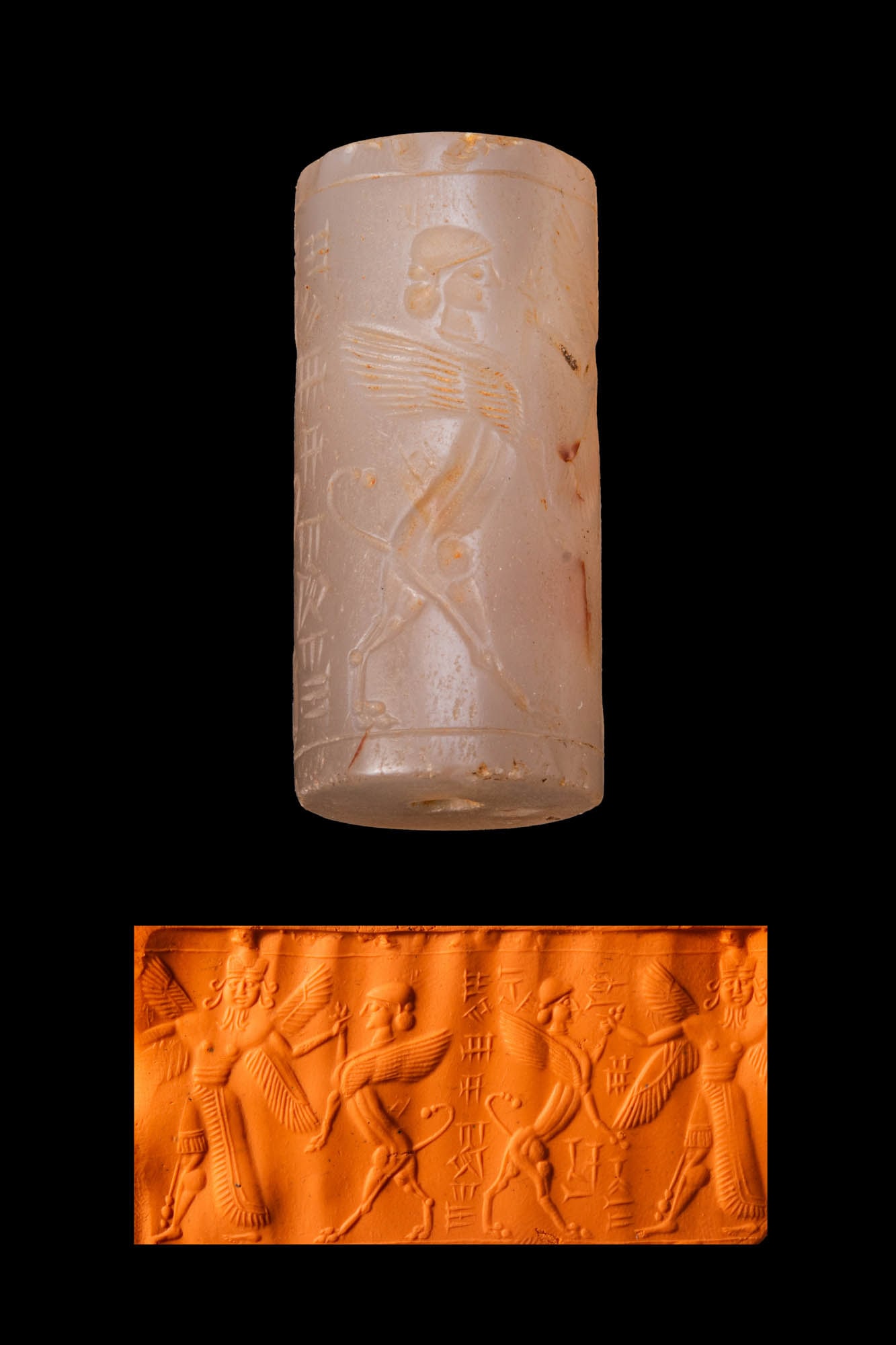 NEO-ASSYRIAN CHALCEDONY CYLINDER SEAL WITH A FOUR-WINGED GENIUS AND A HUMAN-HEADED WINGED LION: Ca. 800 - 600 BC. A chalcedony cylinder seal, drilled longitudinally and engraved with a four-winged genius fighting a human-headed winged lion, with an inscription in the exergue. Size: 42mm x 20mm; 