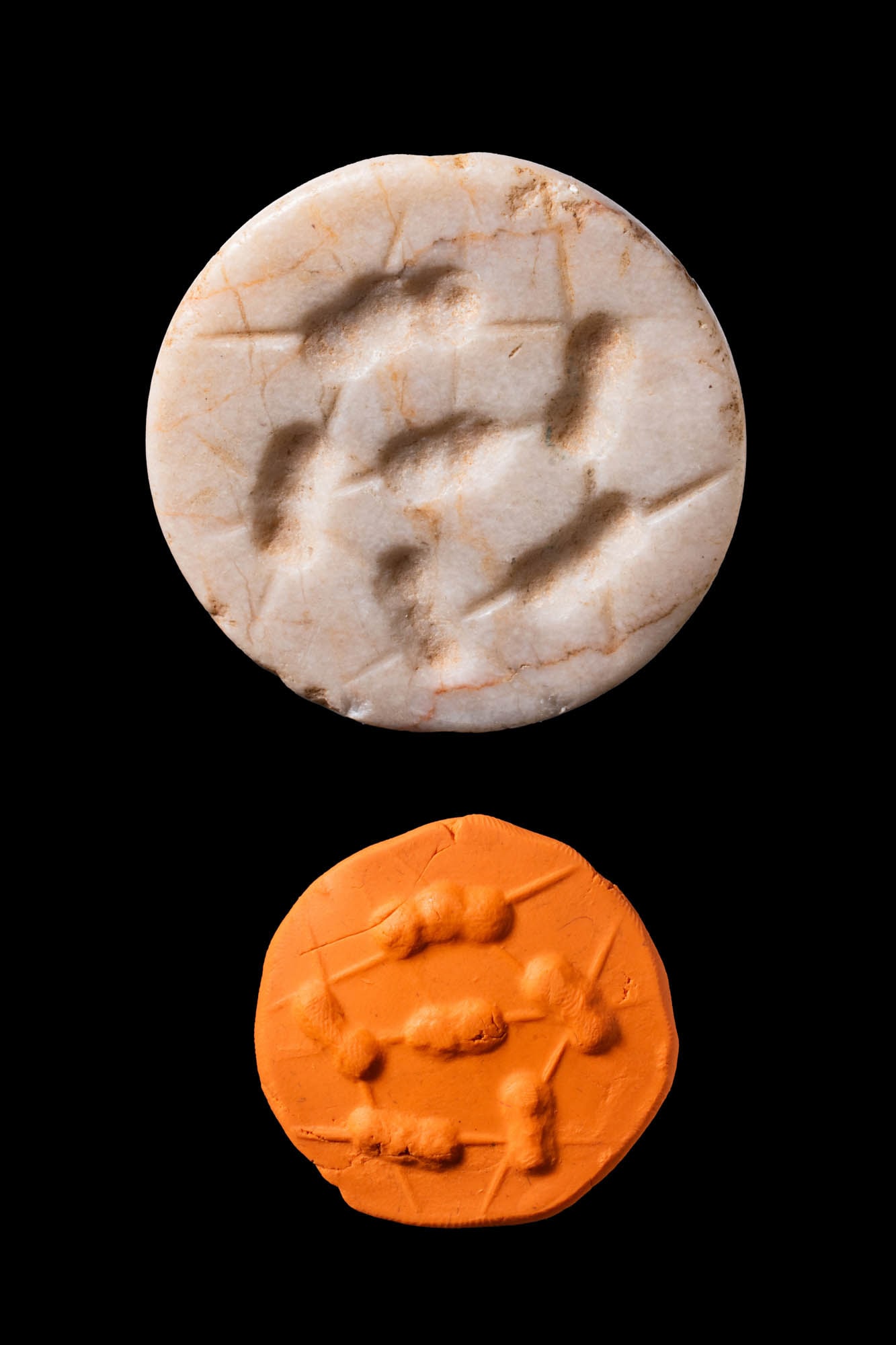 MESOPOTAMIAN WHITE STONE STAMP SEAL WITH ANIMALS - ORIGINAL LAMBERT REPORT: Ca. 3000 BC. A white stone stamp seal with orange veins, in the form of a hemisphere pierced horizontally. The design shows a circle of five small springing animals, with a sixth in the centre, cut wi