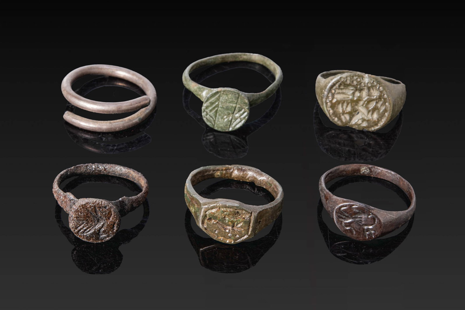 COLLECTION OF VIKING AGE BRONZE RINGS WITH ANIMAL AND GEOMETRICAL MOTIFS AND A SILVER HAIR RING (1 of 3)