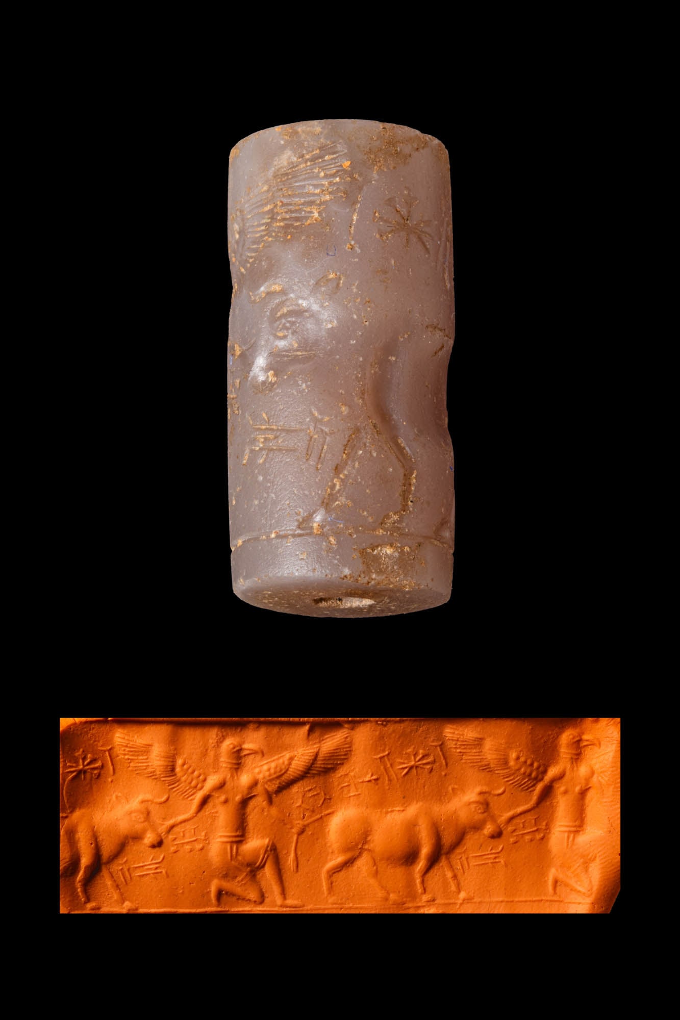 NEO-ELAMITE GREYISH STONE CYLINDER SEAL WITH A WINGED BIRD-HEADED GENIUS AND A BULL: Ca. 600 - 500 BC. A greyish stone cylinder seal, drilled longitudinally and engraved with a kneeling two-winged bird-headed genius grabbing a bull. An inscription is in the exergue. Size: 33mm x 16mm;