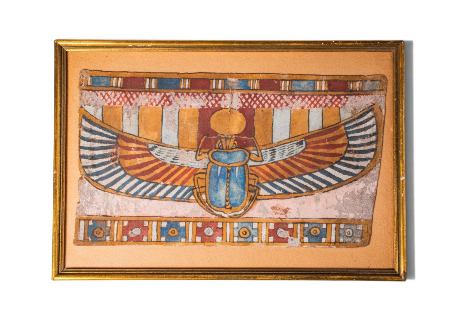 EGYPTIAN PAINTED MUMMY CARTONNAGE WITH WINGED SCARAB: Ptolemaic Period, Ca. 332 - 30 BC. A painted cartonnage of rectangular form, depicting a large winged scarab with a sun disc above, set against a striped polychrome ground and framed above and below b