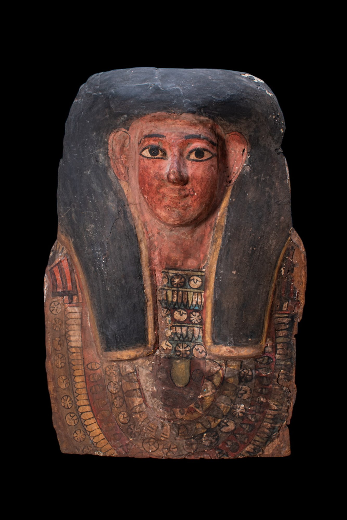 EGYPTIAN UPPER PART OF AN ANTHROPOID COFFIN: Late Period to Ptolemaic Period, Ca. 664 - 30 BC. An upper section of an anthropoid wood coffin with a stucco overlay and painted decoration. The face is painted red, with large almond-shaped eyes out