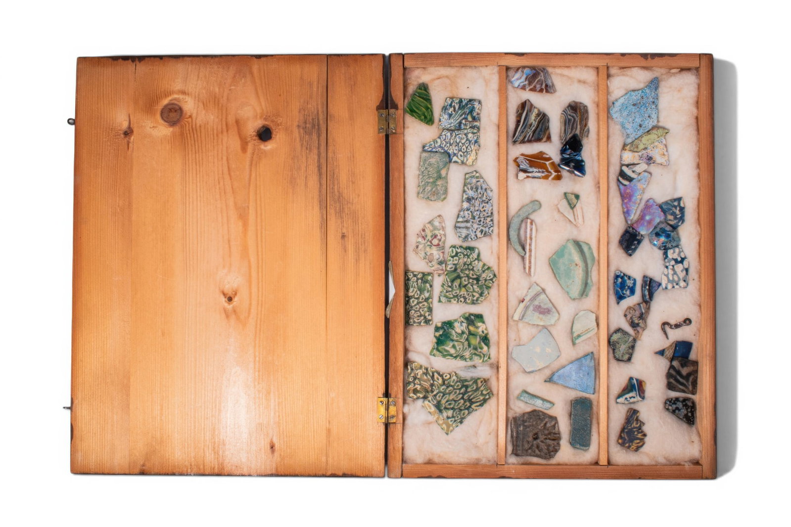 COLLECTION OF ROMANO-EGYPTIAN GLASS INLAYS: Ca. 100 BC - AD 200. A collection of polychrome glass pieces, including assorted inlay fragments; mosaic, marbled and banded glass in varied colours. Accompanied by a compartmented wooden box. For sim