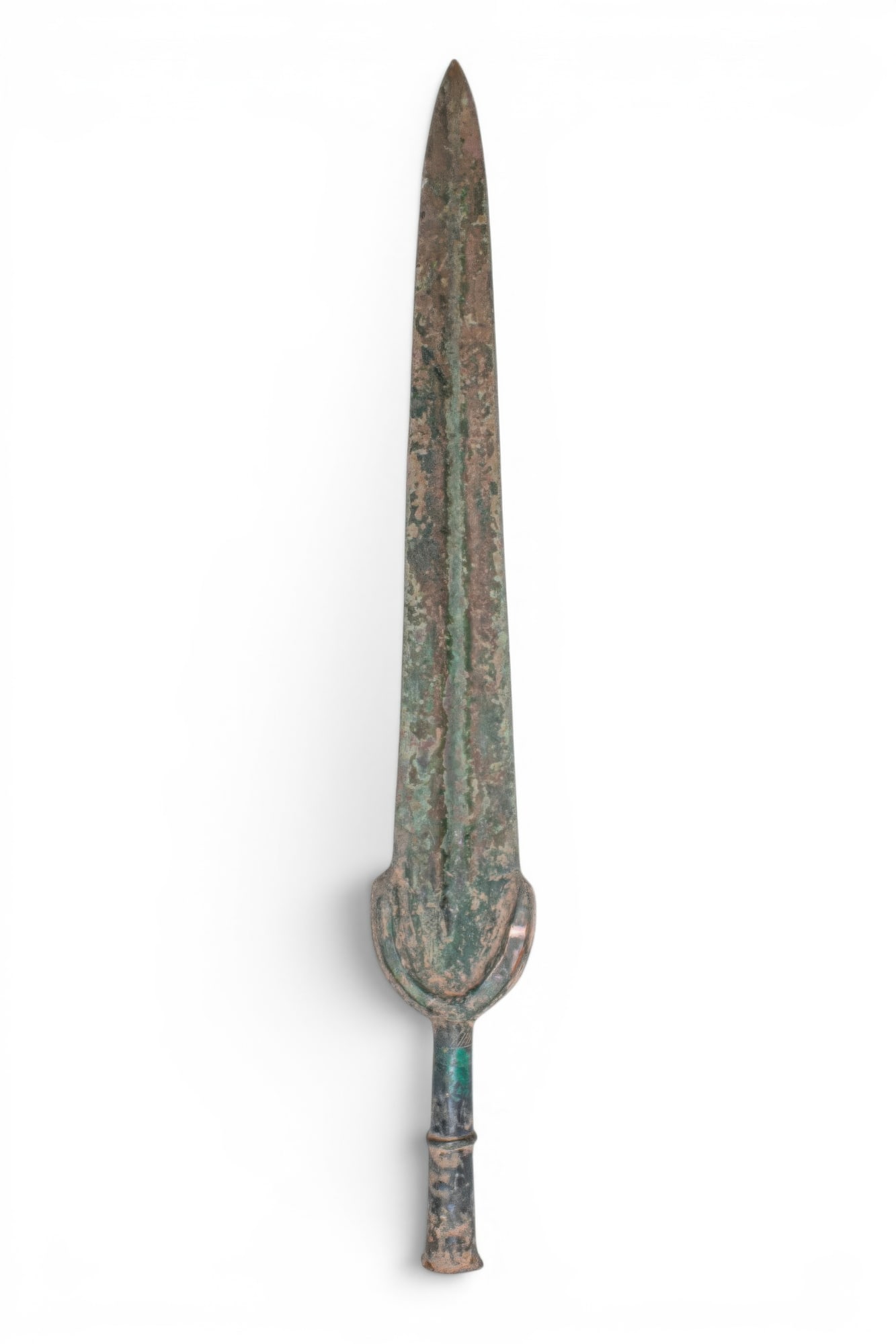 BRONZE AGE / EARLY GREEK PERIOD BRONZE SWORD: Ca. 1200 - 800 BC. A bronze sword with a long blade tapering to a sharp point, the broad central rib running from the base to the tip. The blade descends to an arched guard and a cylindrical grip with