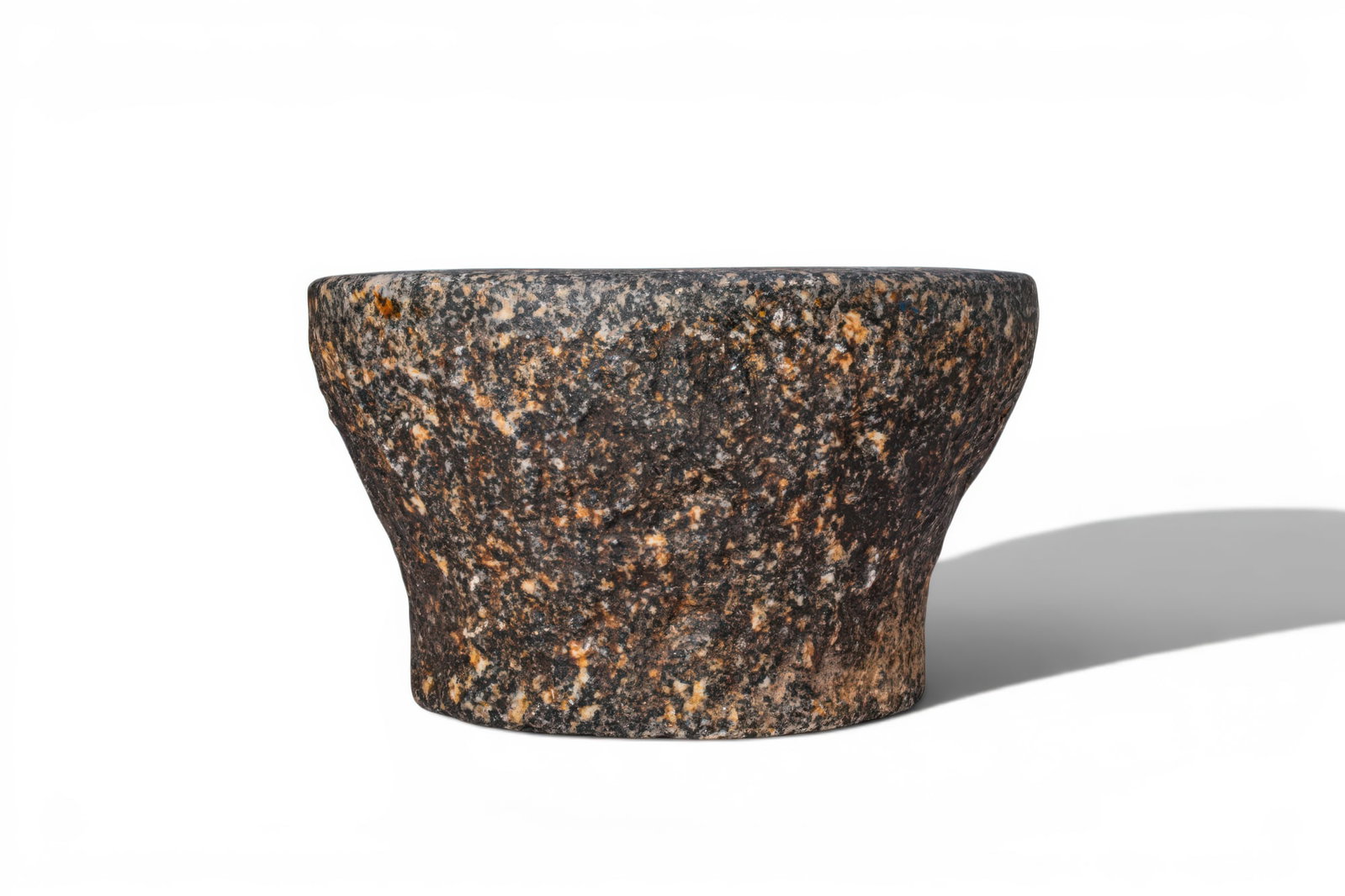 EGYPTIAN BLACK STONE MORTAR: Predynastic Period, Ca. 3100 - 2900 BC. A stone mortar with a rounded body tapering to a short cylindrical foot, the thick everted rim enclosing a deep circular cavity. Size: 170mm x 100mm; Weight: 3.