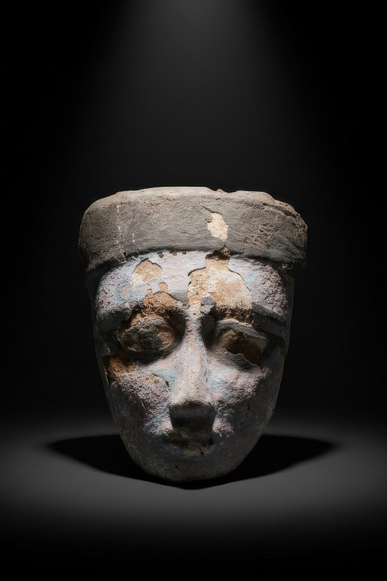 EGYPTIAN PAINTED WOODEN MUMMY MASK: Late Period to Ptolemaic Period, Ca. 664 - 30 BC. A cedar wood mummy mask covered with gesso and painted in polychrome, with an oval face, a projecting straight nose, and a small mouth. The face is fr