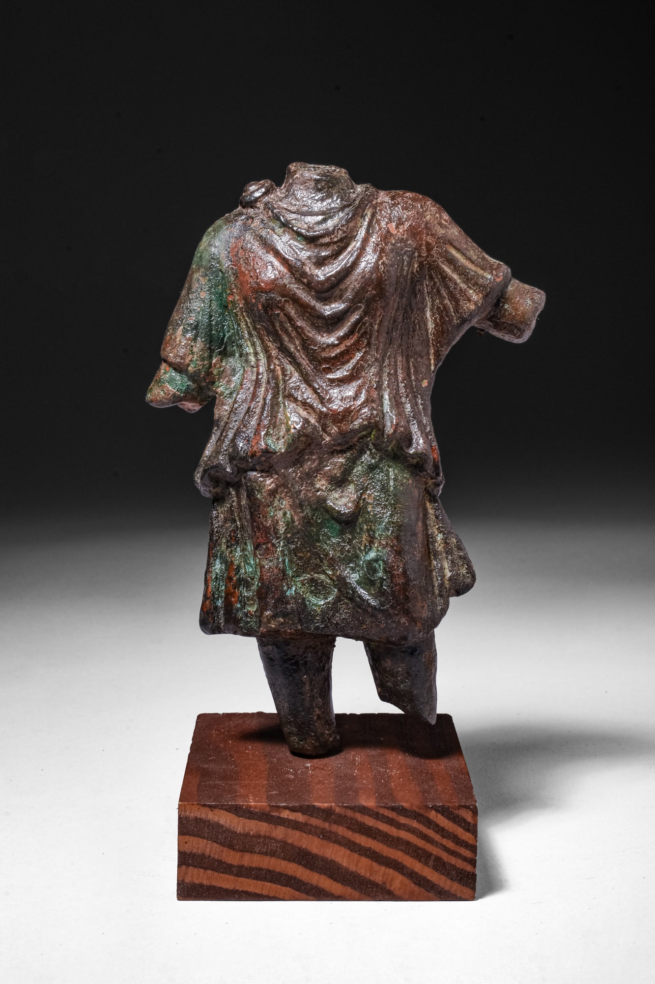 LARGE ROMAN BRONZE TORSO OF DIANA: Ca. AD 200. A bronze torso of Diana, wearing a short chiton, the drapery gathered in heavy folds across the chest and falling in a short skirt above the knees. The figure stands with the weight on the