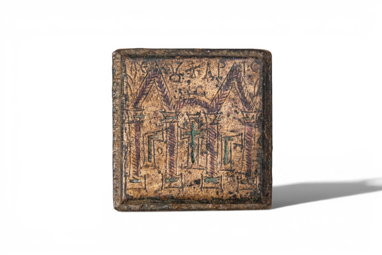 BYZANTINE GILT-BRONZE THREE-OUNCE WEIGHT: Ca. AD 400 - 700. A bronze weight of square form, with bevelled edges and a plain reverse. The obverse is engraved with a stylised architectural setting of three vaults resting on four columns, with a