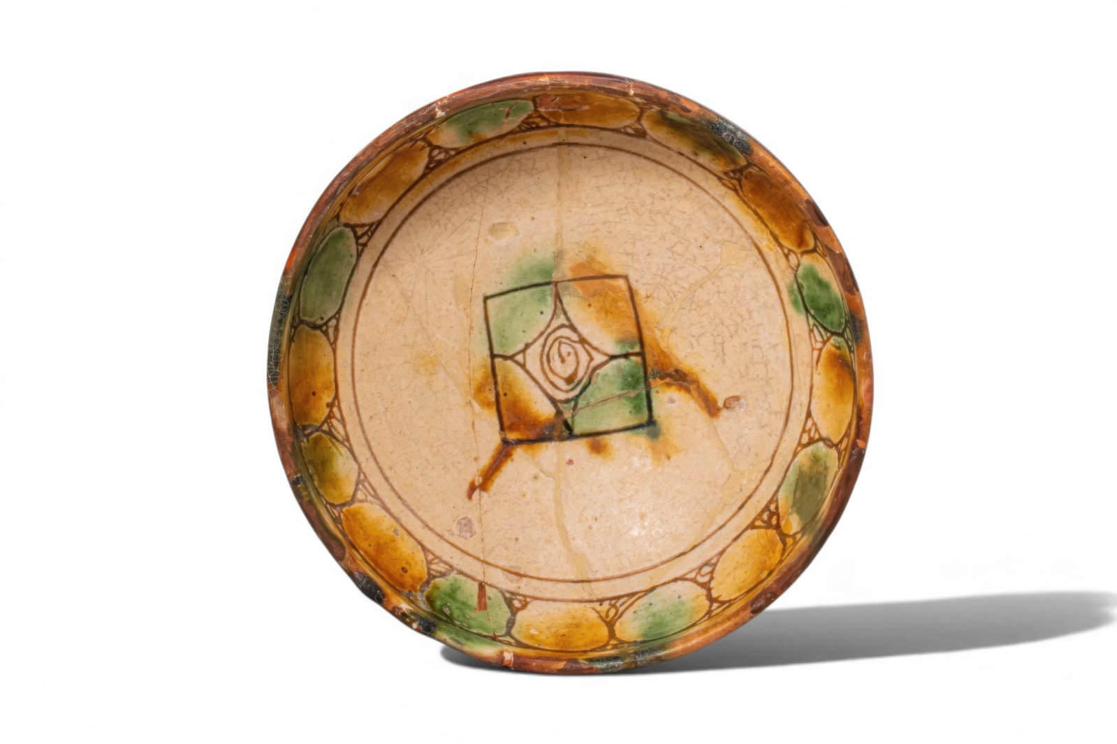 BYZANTINE GLAZED TERRACOTTA BOWL WITH CENTRAL MOTIF - EX ASHMOLEAN MUSEUM COLLECTION: Ca. AD 1300 - 1500. A sgraffito terracotta footed bowl with a deep, rounded body on a low pedestal foot. The exterior is decorated with a brown slip. The interior is centred by a square panel enclosin