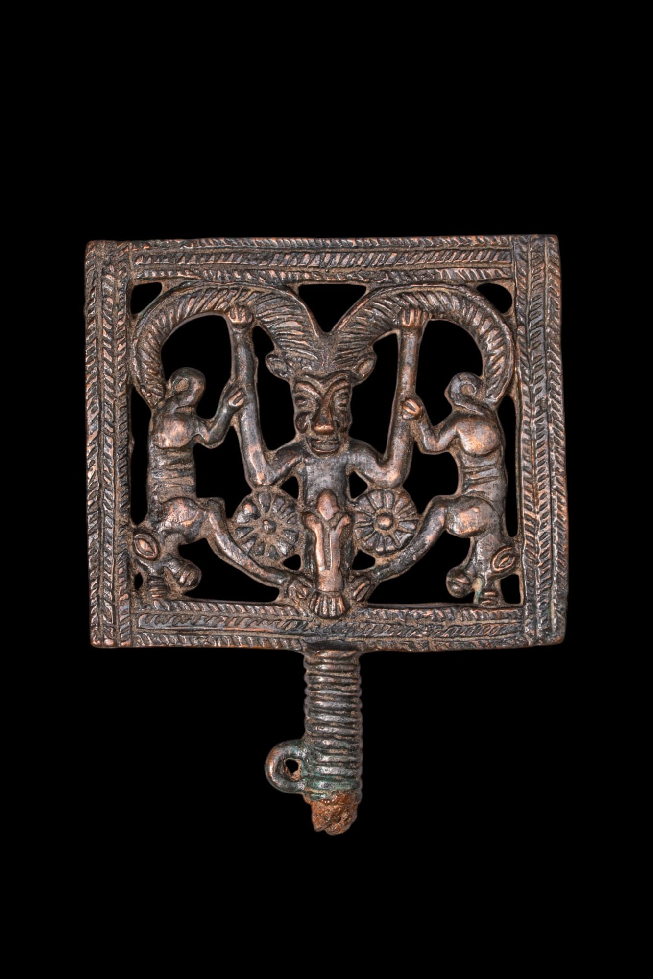 LATE BRONZE AGE / EARLY SCYTHIAN BRONZE PLAQUE WITH HORNED DEMON: Ca. 800 - 500 BC. A bronze openwork plaque with a horned demon flanked by two rosettes and inverted lions, all within a hatched frame, above a short ribbed shaft ending in a suspension loop. Size: 140