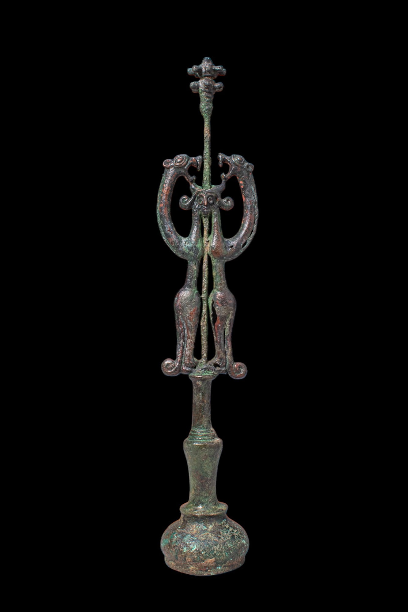BRONZE AGE BRONZE SCEPTRE WITH MASTER OF ANIMALS: Ca. 1200 - 800 BC. A bronze openwork sceptre above a baluster-shaped socket, formed as a pair of confronted felines, possibly lions, with arched necks, open jaws, and slender bodies tapering to long l