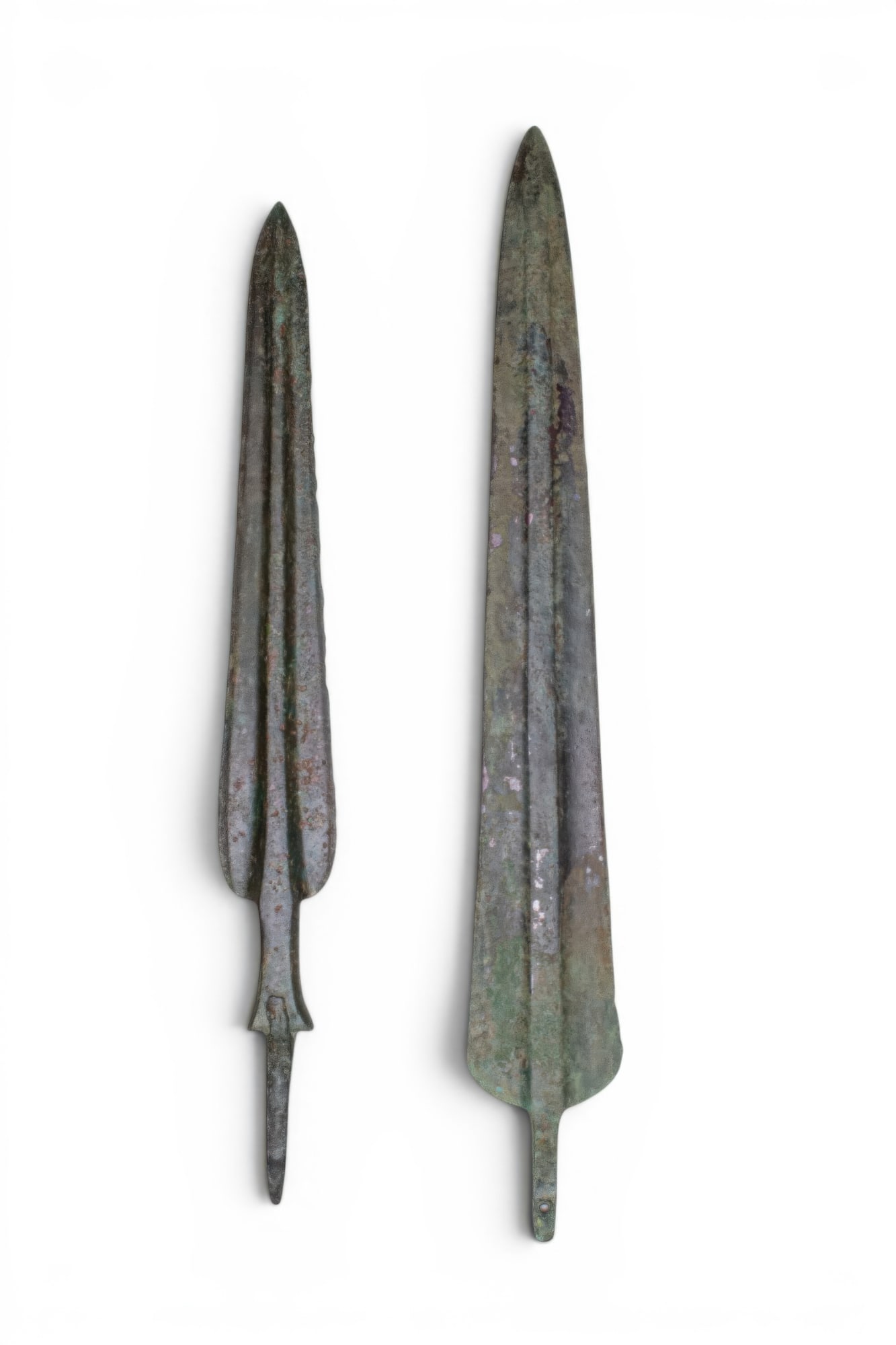 PAIR OF LARGE BRONZE AGE / EARLY GREEK BRONZE SPEARHEADS: Ca. 1200 - 800 BC. A pair of bronze spearheads, each with an elongated leaf-shaped blade with a strong medial ridge extending to a short tang. For similar see: The Metropolitan Museum of Art, Object N