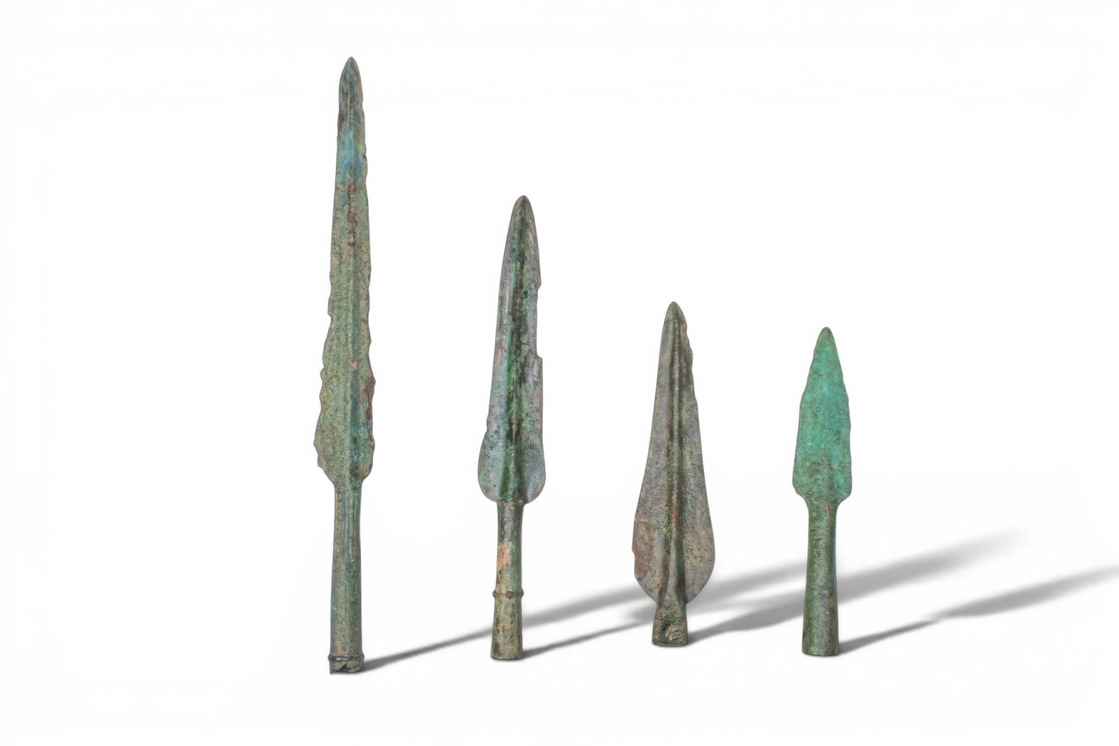 COLLECTION OF GREEK PERIOD BRONZE SOCKETED SPEARHEADS: Ca. 700 - 400 BC. A collection of four bronze spearheads, each with a leaf-shaped blade and a pronounced midrib extending into a tubular socket. Size: 185-355mm x 35-50mm; Weight: 630g Provenance: Fro
