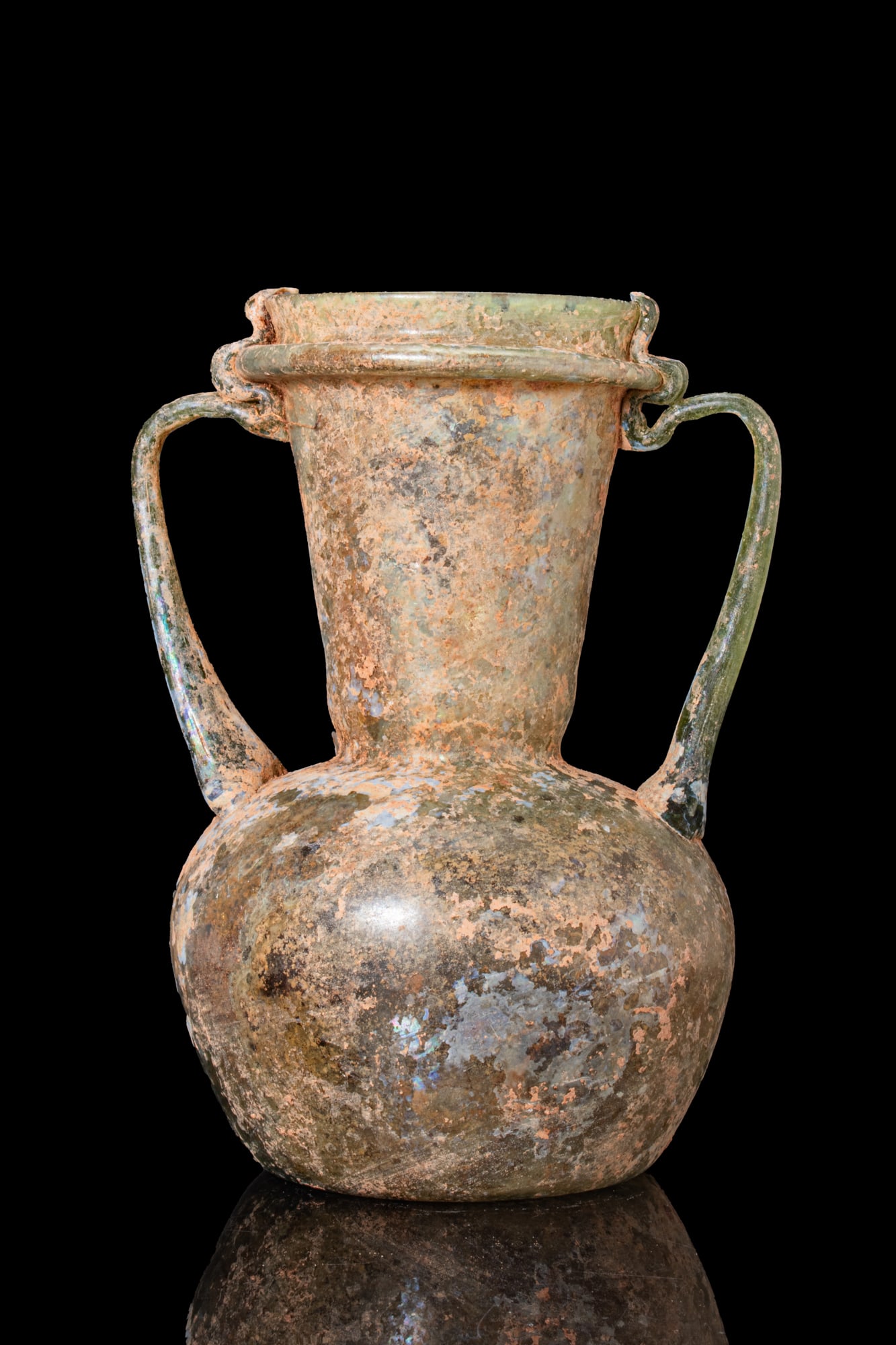 LATE ROMAN GLASS AMPHORISKOS: Ca. AD 300 - 500. A free-blown translucent pale green glass amphoriskos with a globular body, a concave base, a tall flaring neck, and a collared mouth. A pair of strap handles is applied at the shoul