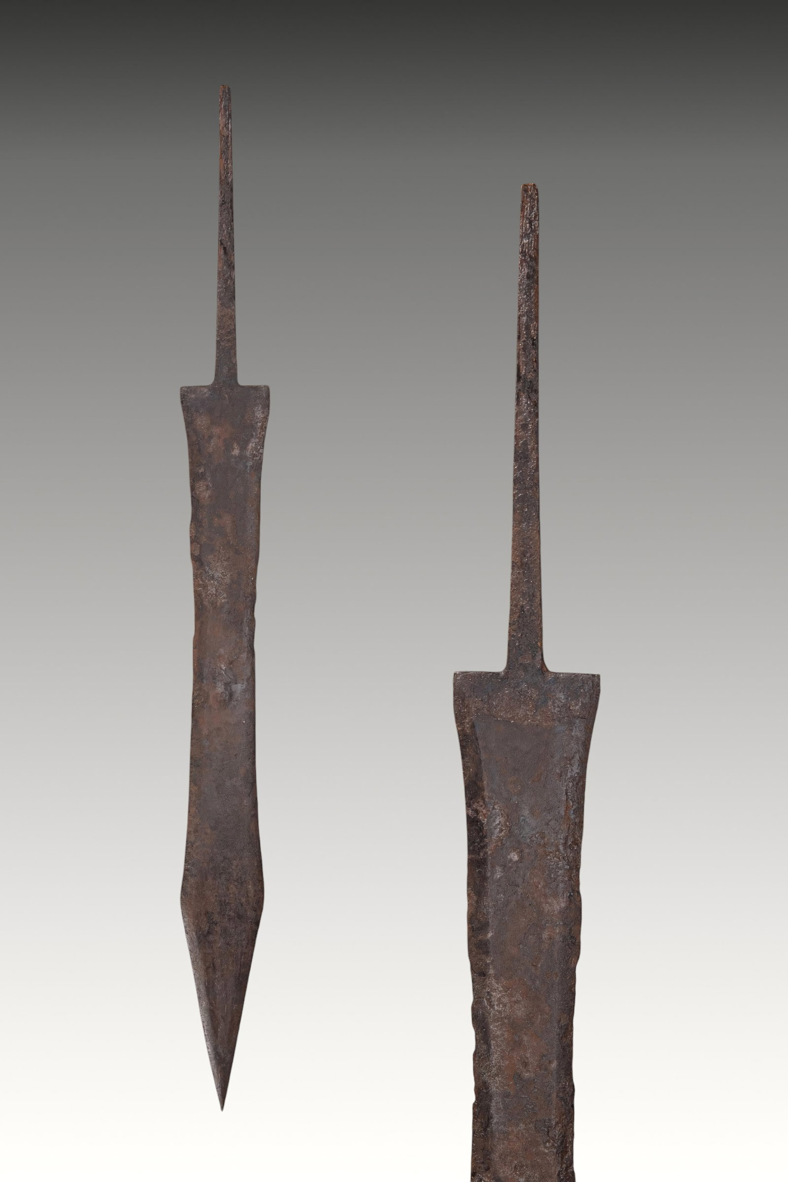 ROMAN LONG IRON GLADIUS MAINZ TYPE: Ca. 15 BC - AD 100. A long iron gladius with a broad double-edged blade, shallowly waisted sides, and a long lanceolate point. Rectangular shoulders frame an elongated narrow tang. For similar see: I.