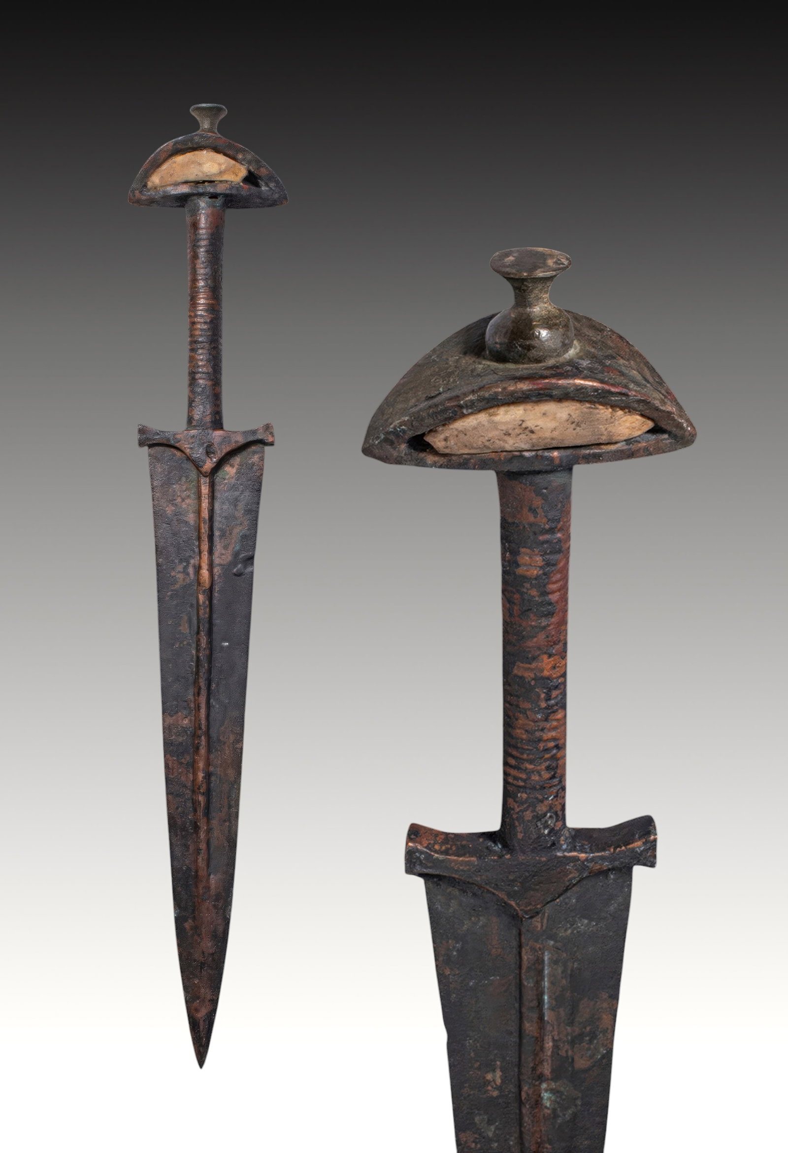 BRONZE AGE / EARLY GREEK PERIOD BRONZE DAGGER WITH STONE-INLAID POMMEL: Ca. 1200 - 900 BC. A bronze dagger with a triangular blade tapering to a sharp point. Each face has a strong central midrib. The shoulders are straight, with a flat guard at the base of the blade. The