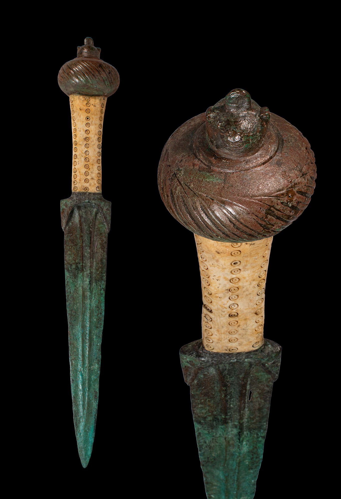 RARE BRONZE AGE BRONZE AND BONE DAGGER WITH DECORATED HANDLE: Ca. 1200 - 800 BC. A bronze dagger with a long blade narrowing to a sharp point, with a raised central rib. The rectangular bone grip is decorated with rows of concentric ring and dot motifs. The hilt