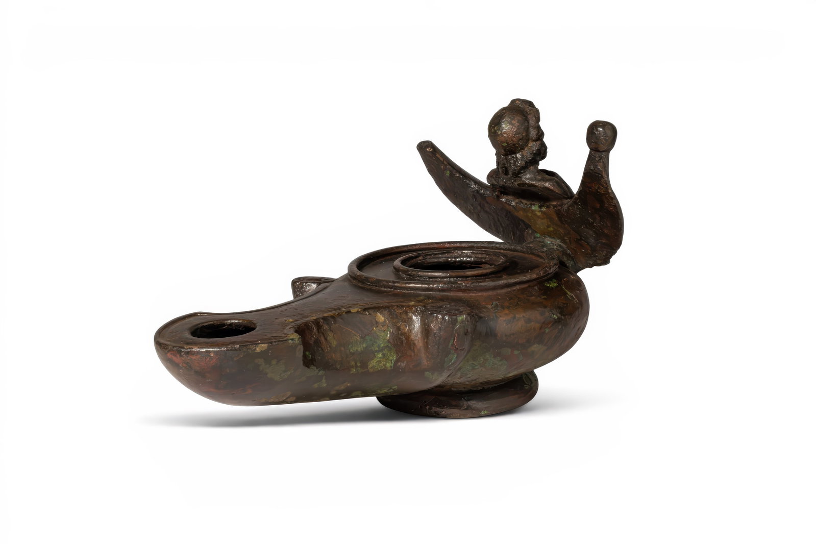 HUGE ROMAN BRONZE OIL LAMP WITH BUST OF JUPITER AND EAGLE: Ca. AD 25 - 75 . A bronze oil lamp with a rounded body and a long channelled nozzle with a circular wick hole, the volutes set to either side. The circular discus has a central filling hole within two