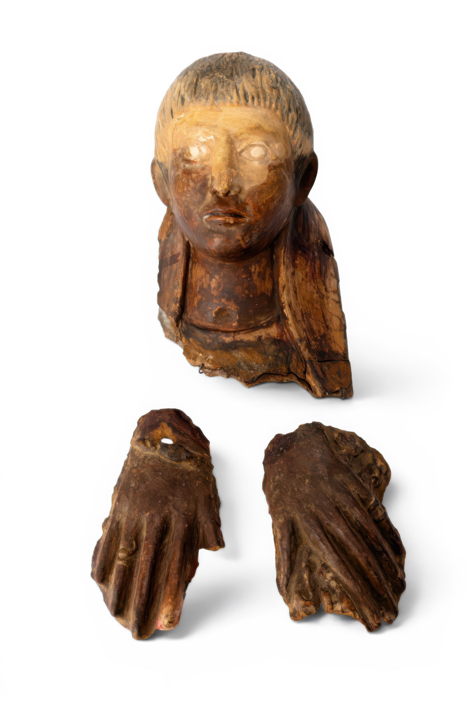RARE ROMAN-EGYPTIAN MALE FUNERARY MASK WITH TWO EGYPTIAN HANDS IN CARTONNAGE: Ca. AD 100 - 200. A plaster and linen funerary portrait mask with a youthful face, large eyes, a straight nose and thin lips. Short dark hair is arranged in a close fringe above the forehead. The sepa