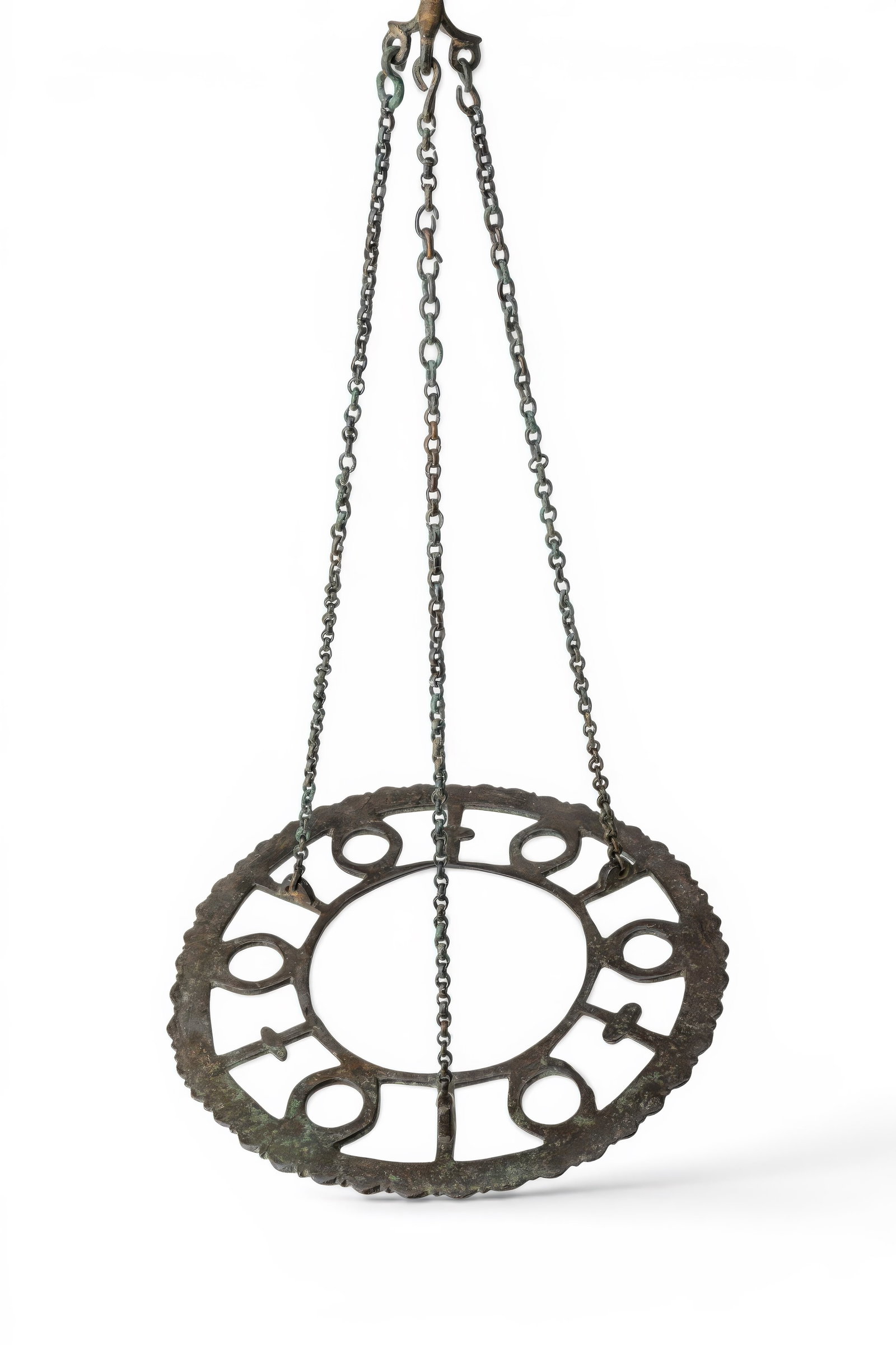 BYZANTINE BRONZE POLYCANDELON WITH ORIGINAL CHAINS: Ca. AD 600 - 800. A bronze polycandelon with a circular openwork frame, scalloped outer edge and broad central opening. The surrounding register is divided into radial compartments with six oval lamp 