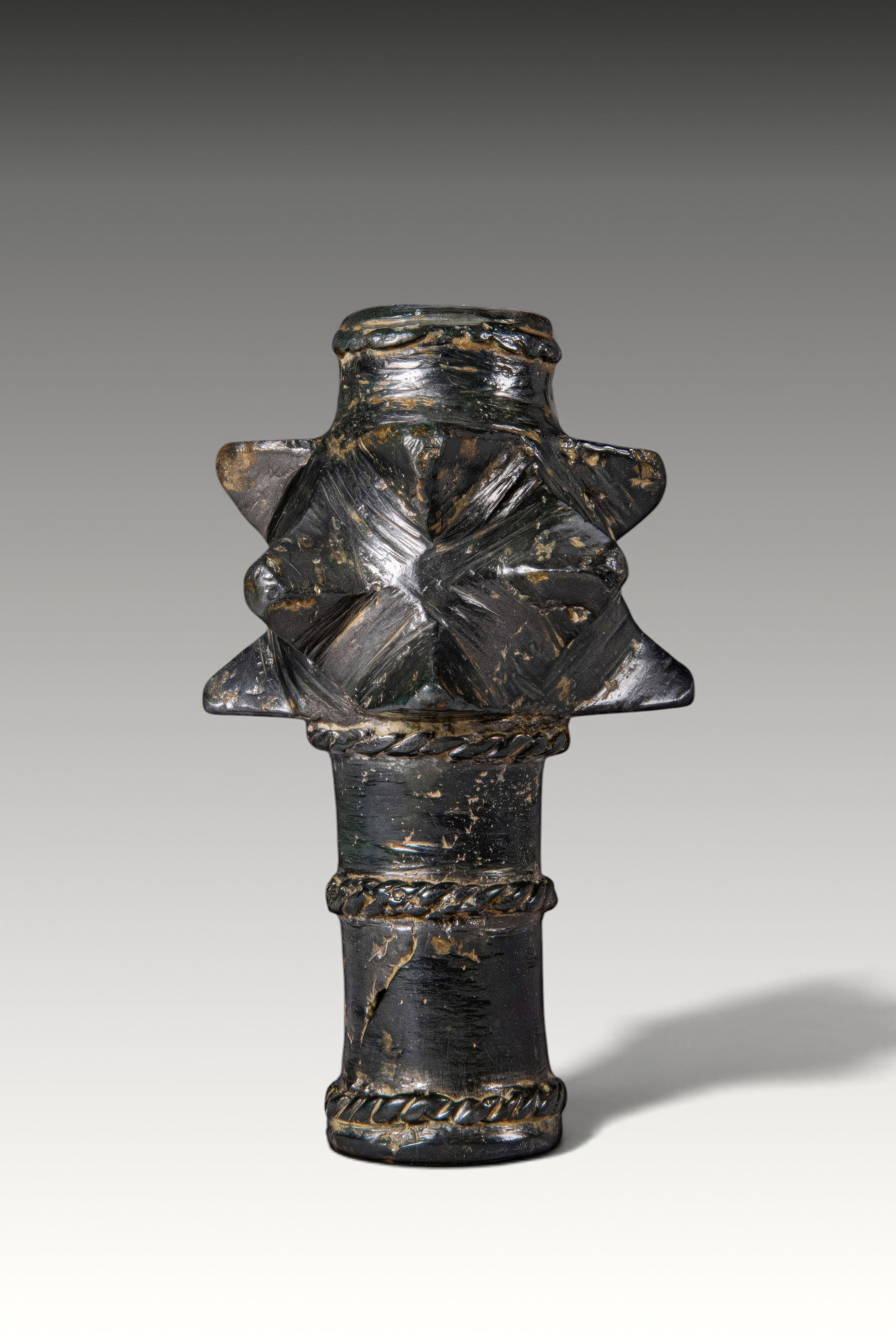 MEDIEVAL BRONZE MACE HEAD: Ca. AD 1200 - 1400. A bronze mace head with a cylindrical socket encircled by twisted rope bands. The upper section is set with three tiers of broad triangular projections. Size: 115mm x 65mm; Weight:
