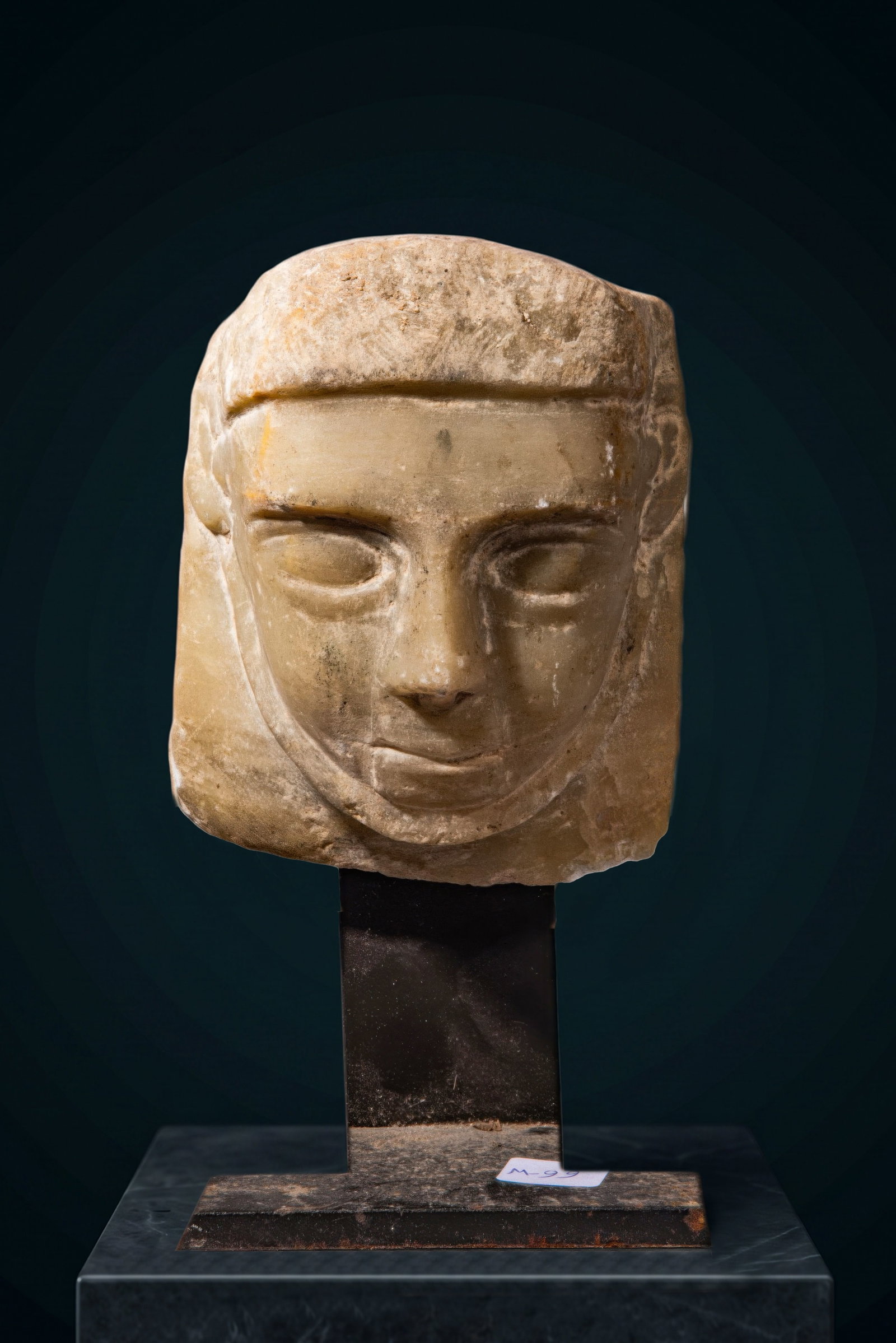 SOUTH ARABIAN ALABASTER HEAD OF A MAN: Ca. 300 - 100 BC. An alabaster male head with an oval face, large almond-shaped eyes, a long narrow nose and softly modelled lips. The ears are carved at the sides. Straight-cropped hair is marked by 