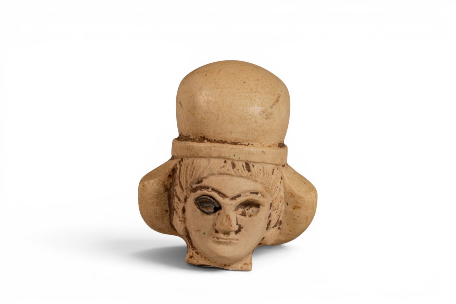 MESOPOTAMIAN STONE HEAD OF A WOMAN WEARING A POLOS CROWN: Ca. 2200 - 1800 BC. A stone head of a woman with a rounded face, straight nose, and recessed almond-shaped eyes beneath arched brows. The hair is arranged in straight strands framing the forehead and 
