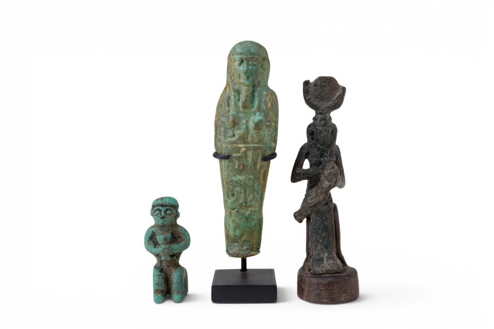 COLLECTION OF EGYPTIAN BLUE EGYPTIAN, FAIENCE AND BRONZE FIGURINES: Late Period, Ca. 664 - 332 BC. A collection of three figurines, including, from left to right: a blue faience seated figure with a close-fitting cap, modelled facial features and hands held before the