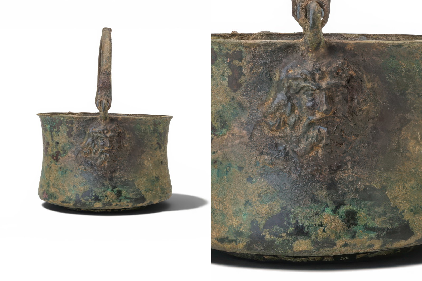GREEK DEEP BRONZE BOWL WITH HANDLE ADORNED WITH HEADS OF ZEUS: Ca. 400 - 200 BC. A deep bronze bowl with a slightly waisted cylindrical body and everted rim, set on a low circular foot. A high arched handle is attached to loops at either side of the rim. Each att