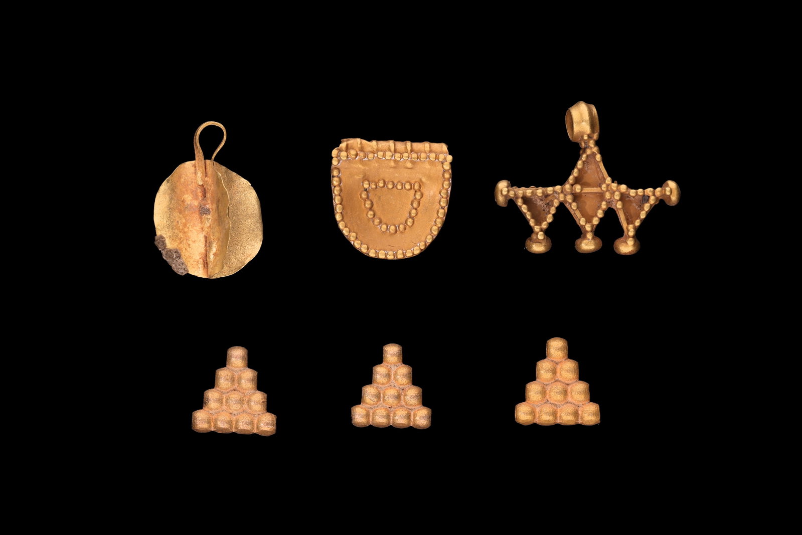 COLLECTION OF GREEK GOLD PENDANTS: Ca. 400 - 200 BC. A collection of gold pendants, including, from top left: a circular pendant with a folded suspension loop; a shield-shaped pendant with beaded borders; a pendant with a tubular suspe