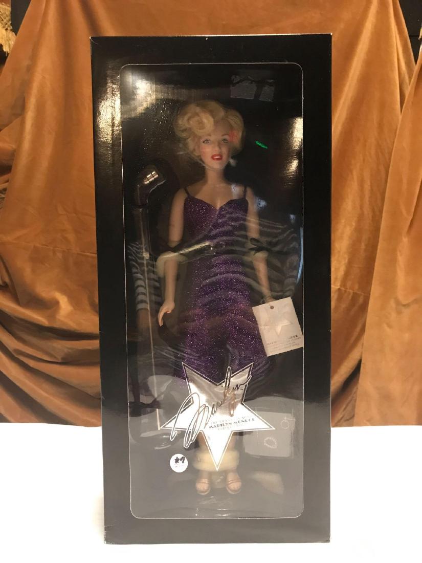 FRANKLIN MINT MARILYN 16 " VINYL DOLL: ENTERTAINING THE TROOPS Beautiful 16" Marilyn in her stunning purple shimmering ensemble from "Entertaining the Troops." The jewelry that accompanies this outfit is all complete. Her USO microphone is