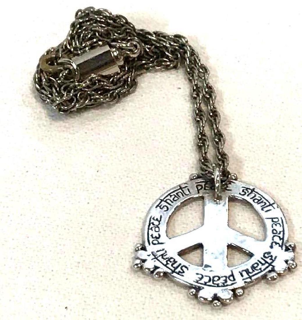 Shanti Peace Sanskrit Yoga Charm Necklace: Shanti means peace, rest, calmness, tranquility, or bliss. Om shanti shanti is a very popular Buddhist meditation chant. This necklace has a silver colored metal charm of a peace sign with