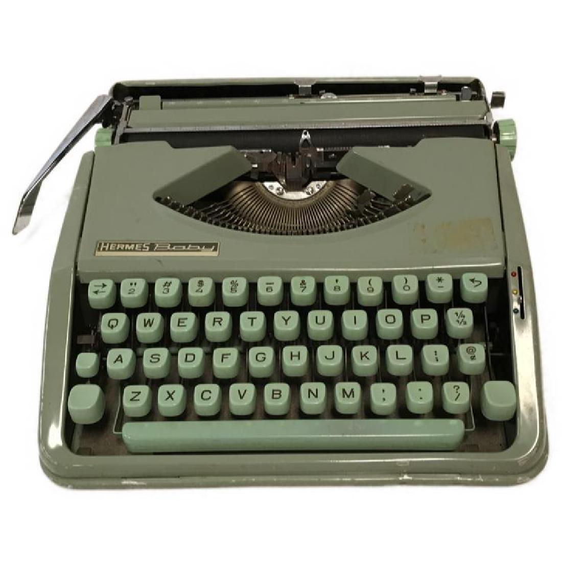 Hermes Baby Portable Typewriter: The Hermes Baby was Produced from 1935 to 1976. It remains today as one of the most highly collectible and well loved typewriters. It is in good shape, but could use a good cleaning. 