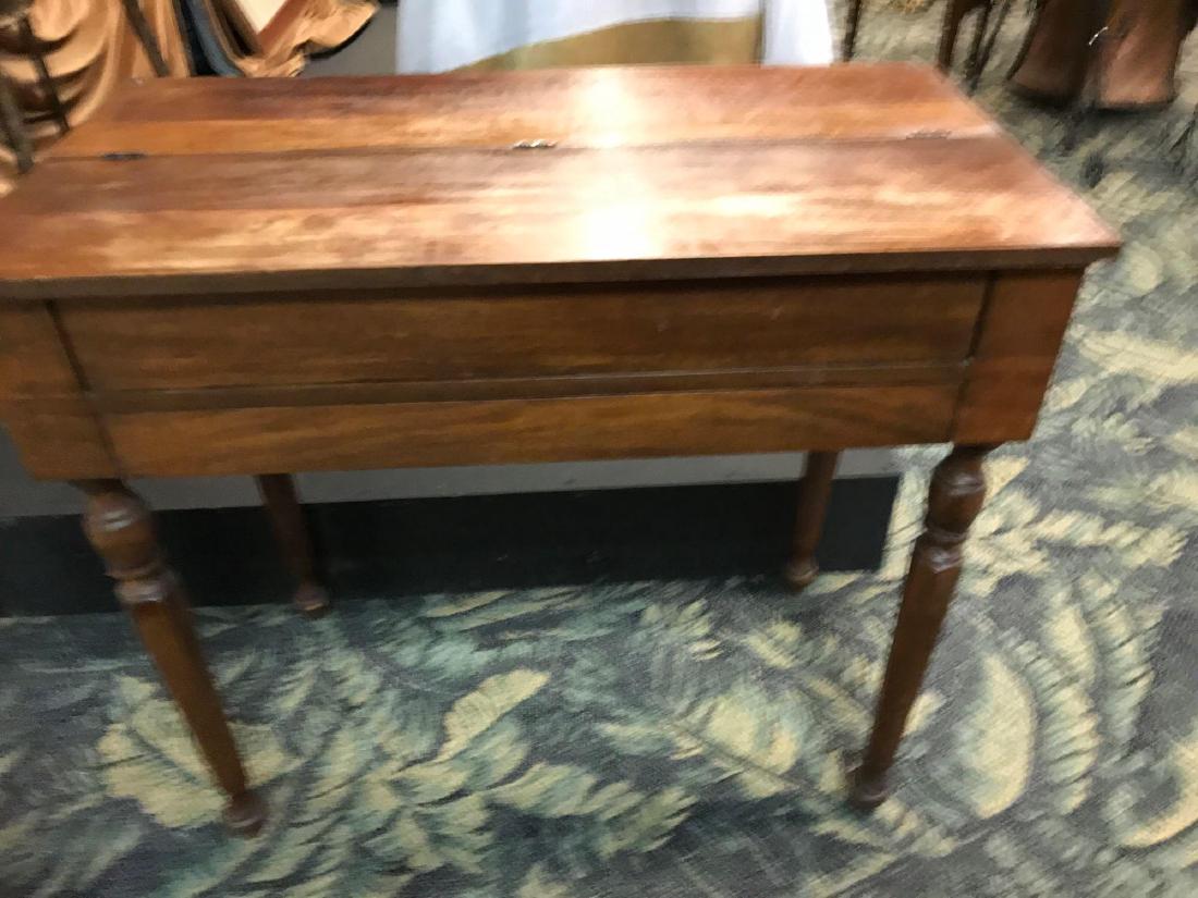 Vintage Writing Desk Flip Top: Vintage writing desk with flip top, and carved spindle legs. It has a middle drawer with compartments on either side. The writing surface can be removed to use storage area underneath.&nbs