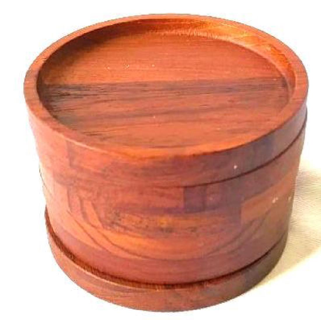 Mid-century Teak Wood Coaster Set: 6 teak wooden coasters. These are a must have for any mid-century modern home. They measure approximately 3" across. We also have some matching teak napkin rings in the auction.
