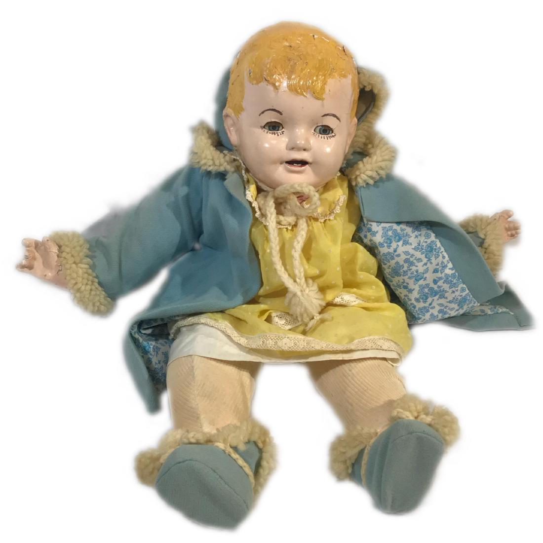 Porcelain Doll with Handmade outfit: This vintage doll has a porcelain head, hands and legs. It is extremely delicate and chipping away. It would be great fro display, but would never survive a loving child. I could not find any ta